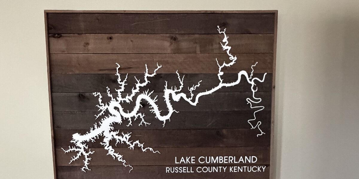 A wooden relief map of Lake Cumberland mounted on the terminal wall, lettered Lake Cumberland, Russell County Kentucky